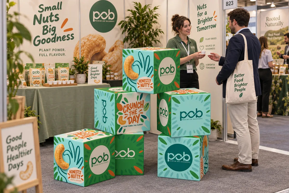 Stacked 3D cube displays with branded graphics at a food trade show booth